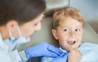 a child being examined by a dentist, representing orthodontic treatment for children