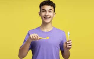 Young boy keeps his teeth clean by following the dental routine given to him by his dentist.